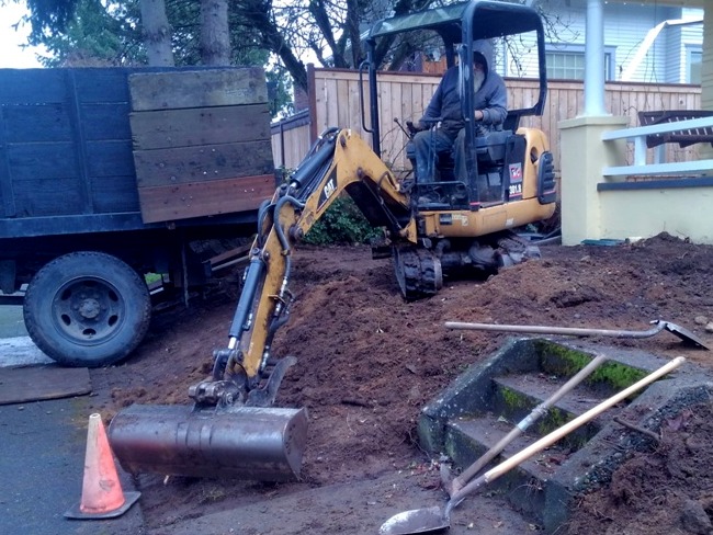 Tacoma Landscaping excavator removing plants